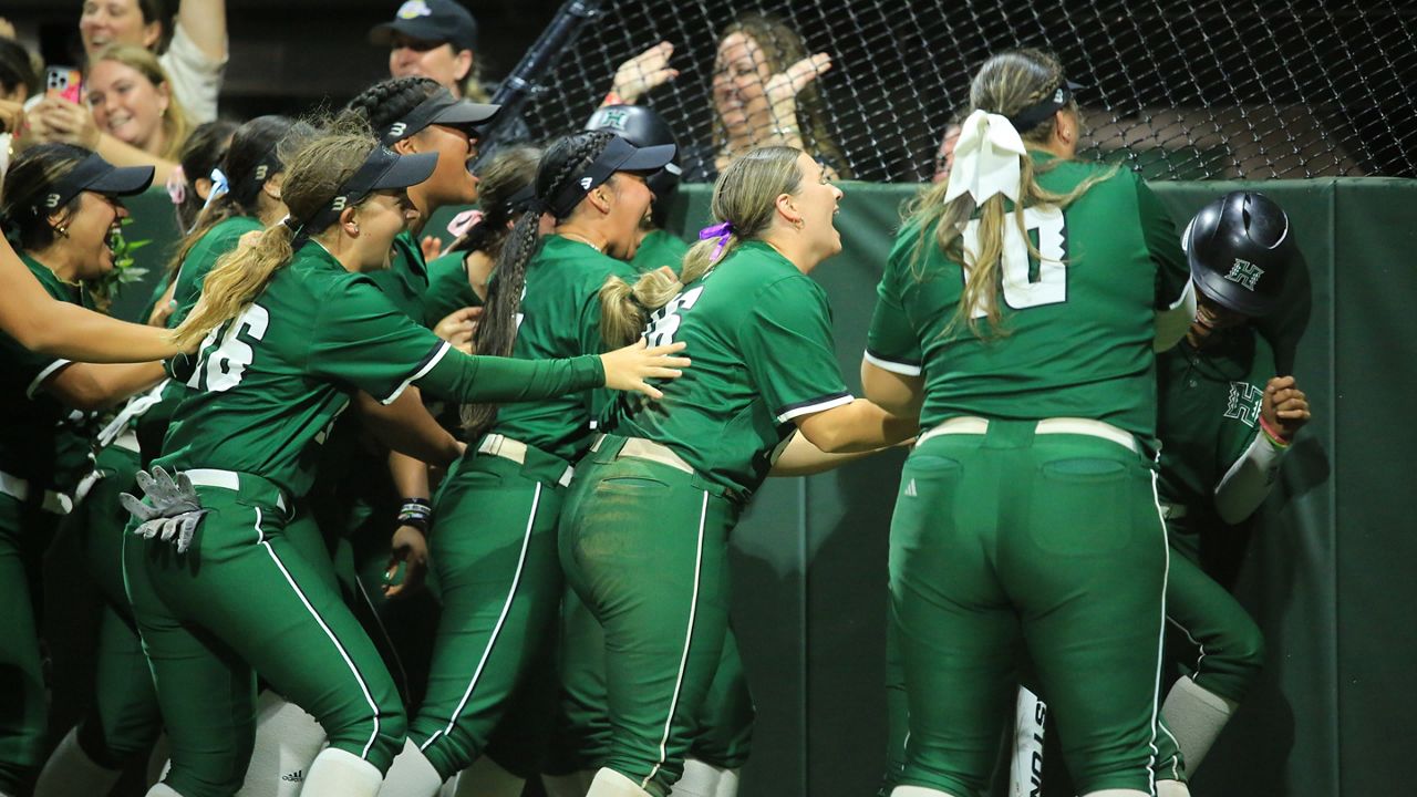 Hawaii teammates mashed Mya'Liah Bethea against the backstop padding after her walk-off sprint from second base against Cal State Fullerton at Rainbow Wahine Softball Stadium on Friday night.