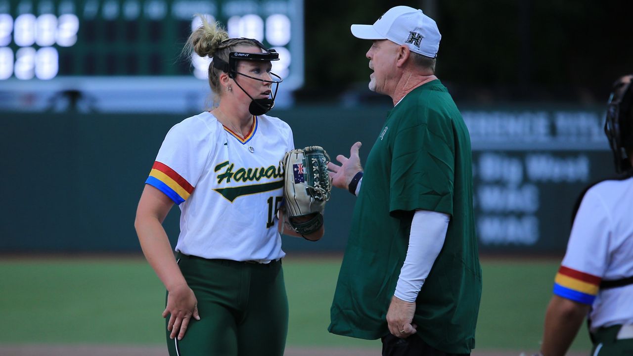 Hawaii coach Bob Coolen spoke to pitcher Millie Fidge at Rainbow Wahine Softball Stadium on March 1. 