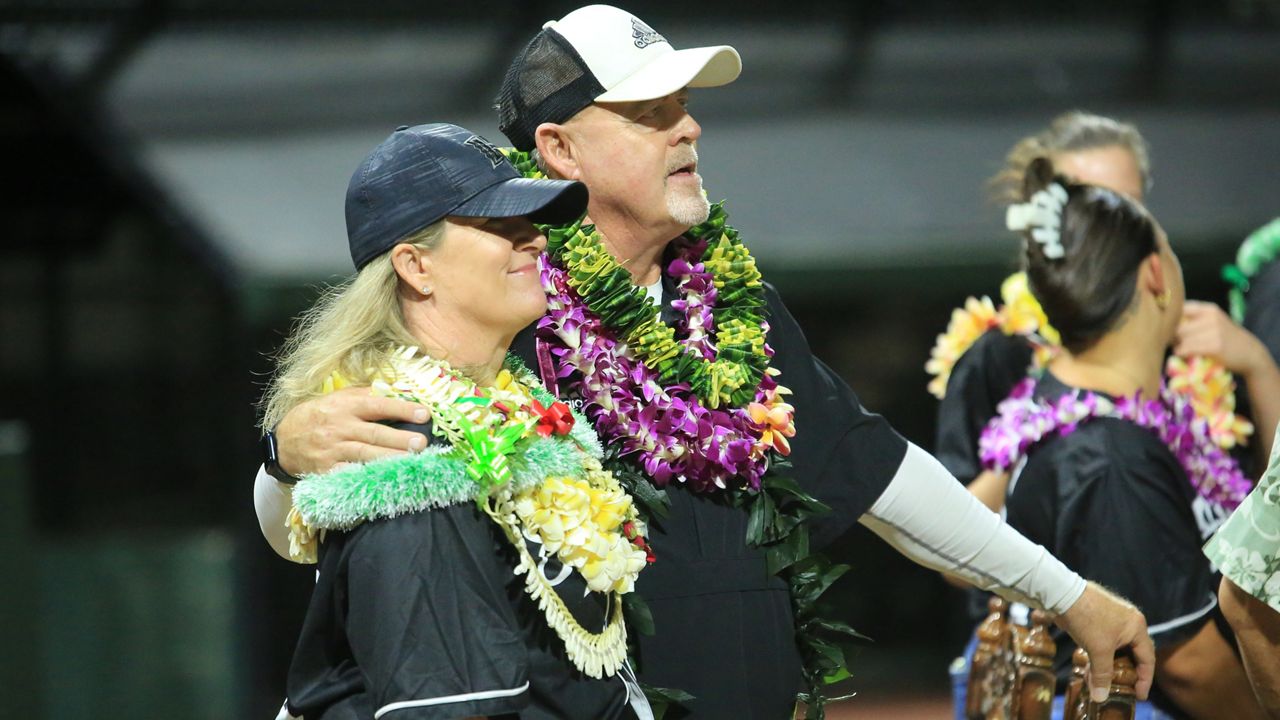 Hawaii softball coach Bob Coolen and wife Nanci watched tributes from alumnae on the Rainbow Wahine Softball Stadium video board after Friday's game against UC San Diego.