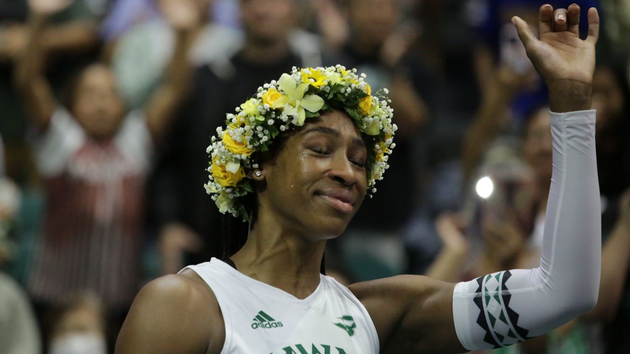 Hawaii All-America middle Amber Igiede shed a tear and flashed a shaka during her senior night ceremony after the Rainbow Wahine beat Long Beach State in four sets Saturday. 