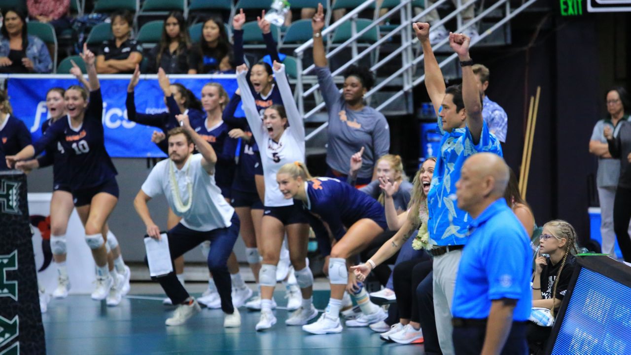 Pepperdine head coach Scott Wong, right in blue shirt, raised his fists and the rest of the Waves celebrated as they secured the program's first win in Honolulu since 1997.