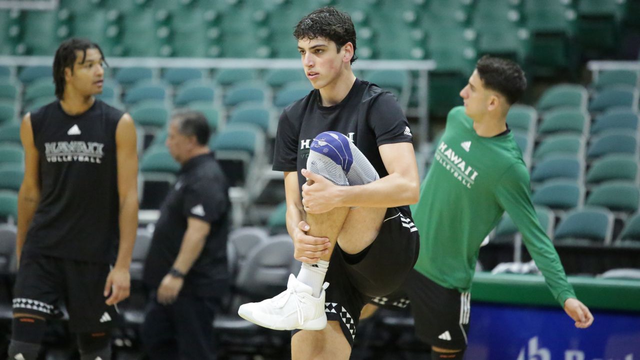 Hawaii freshman setter Tread Rosenthal stretched during warmups for the Rainbow Warriors' team practice on Tuesday. UH opens up the 2024 season against Loyola Chicago at the Stan Sheriff Center on Wednesday night. 