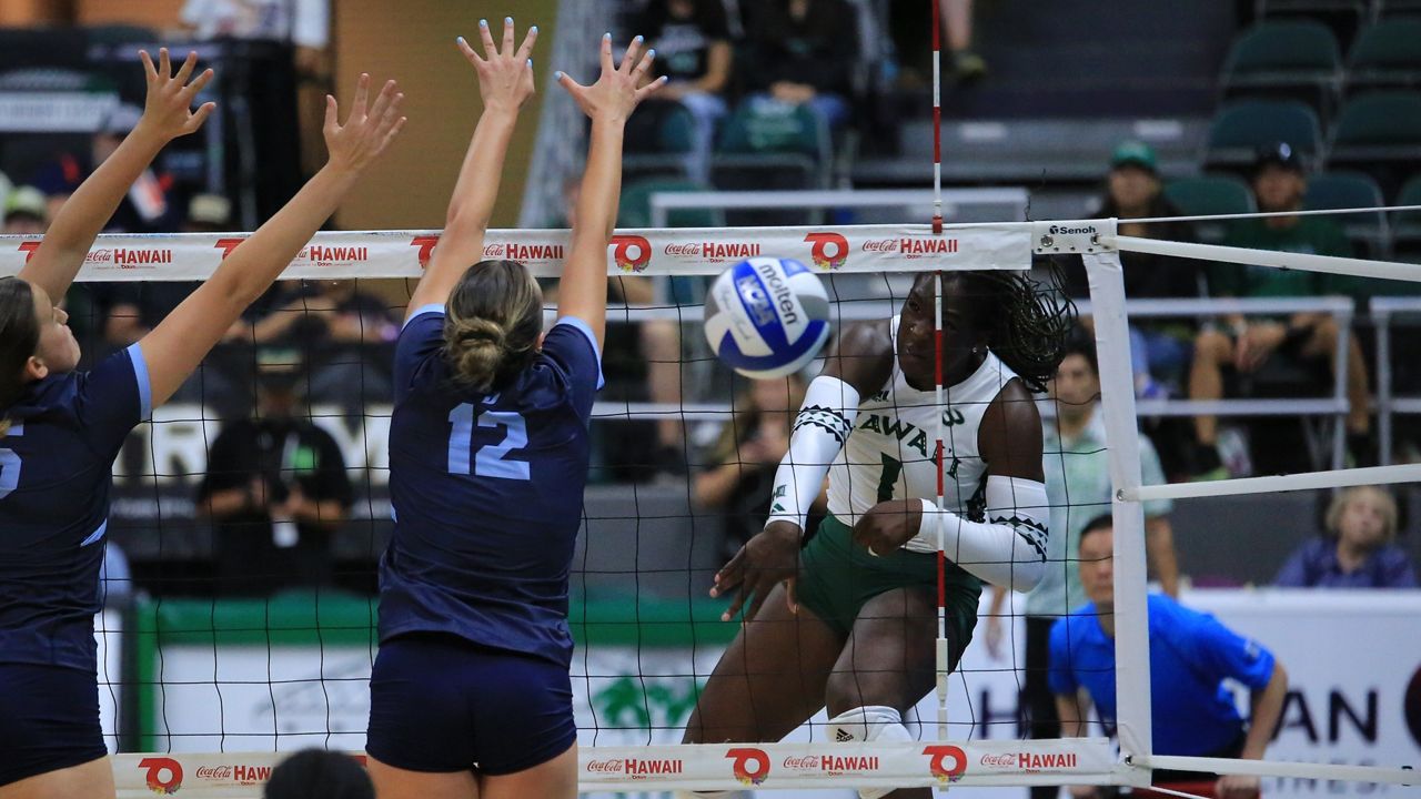 Hawaii hitter Stella Adeyemi went down the line for a kill against San Diego's double block on Sunday night. 