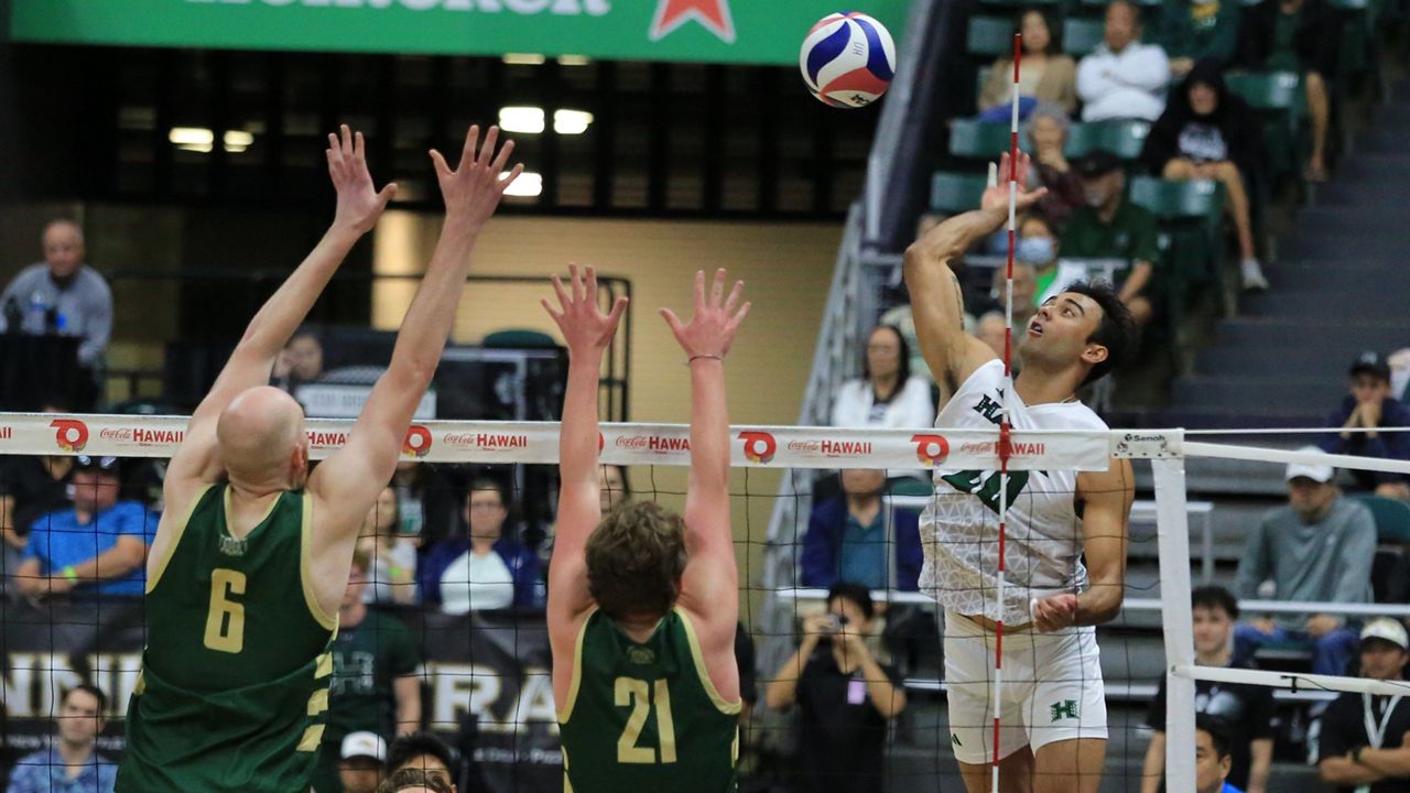 Hawaii hitter Keoni Thiim elevated to take a swing against the block of Missouri S&T's Caleb Rohlwing and Grant Edmonds in the third set of UH's sweep victory on Thursday night.