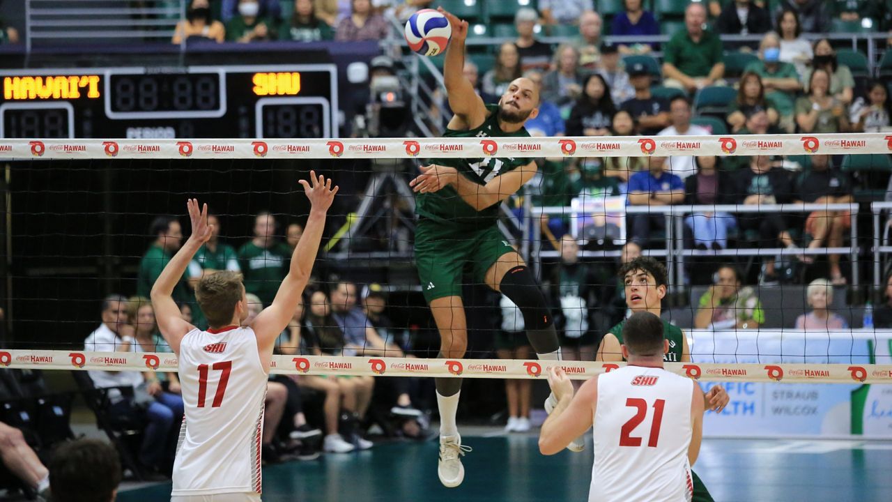 Hawaii middle Guilherme Voss put down a kill against Sacred Heart on an assist from setter Tread Rosenthal, lower right, at the Stan Sheriff Center on Sunday.