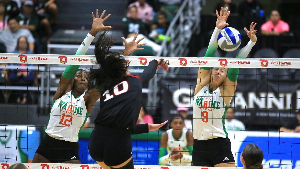 CSUN's Tatiana Turgeon took a swing into the Hawaii block of Miliana Sylvester (12) and Tali Hakas (9) on Sunday night.