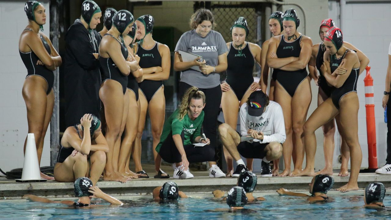 Hawaii water polo coach Maureen Cole, middle in green, spoke to the Rainbow Wahine during a timeout against Cal at the Duke Kahanamoku Aquatic Complex on March 25.