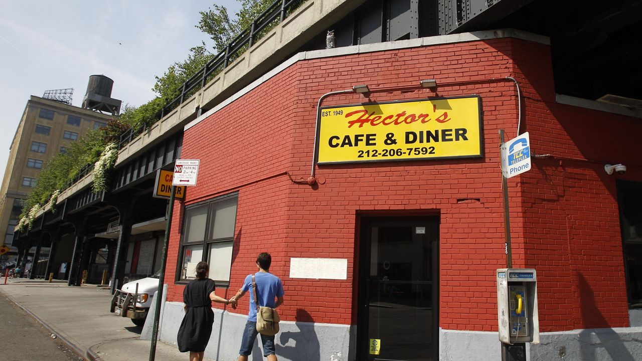 This Sunday, June 5, 2011 photo shows Hector's Cafe and Diner, a haven for meatpackers, truckers, construction workers, and trendy club-goers looking for cheap, solid eats at odd hours, is shown beneath Section 1 of the High Line in New York. The ribbon was cut Tuesday, June 7, on the long-awaited second section of the High Line. The new section ends at 30th Street, adding 10 blocks and doubling the length to one mile. The first segment opened in June 2009 and runs from Gansevoort Street to 20th Street. (AP Photo/Kathy Willens)