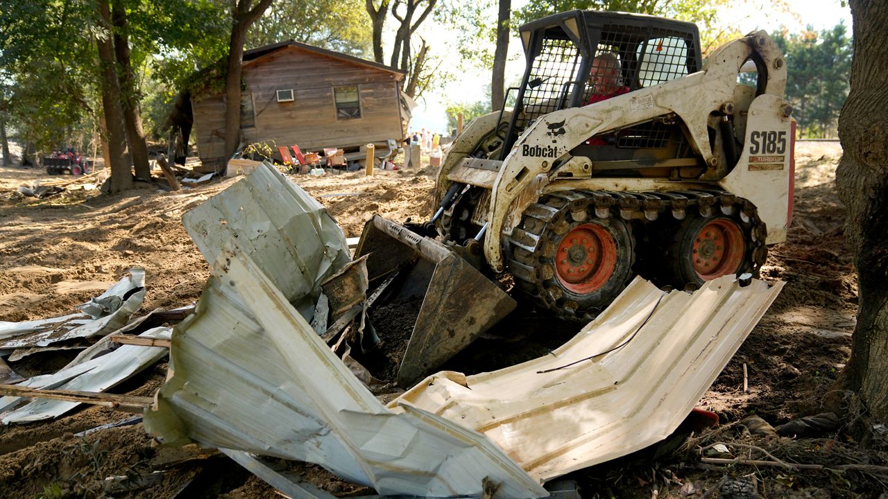 Debris left in the aftermath of Hurricane Helene is cleared Saturday, Oct. 5, 2024, in Del Rio, Tenn. (AP Photo/Jeff Roberson)