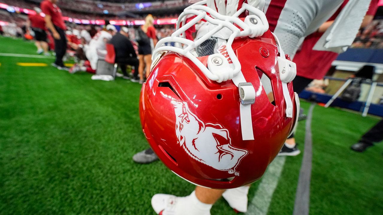 Arkansas fullback Kyle Thompson holds his helmet while on the sideline during the first half of an NCAA college football game against Texas A&M, Sept. 28, 2024, in Arlington, Texas. (AP Photo/Julio Cortez, File)