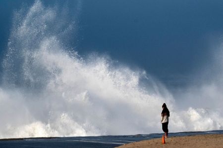 Huge surf pounds beaches on West Coast and in Hawaii with some low-lying  coastal areas flooding