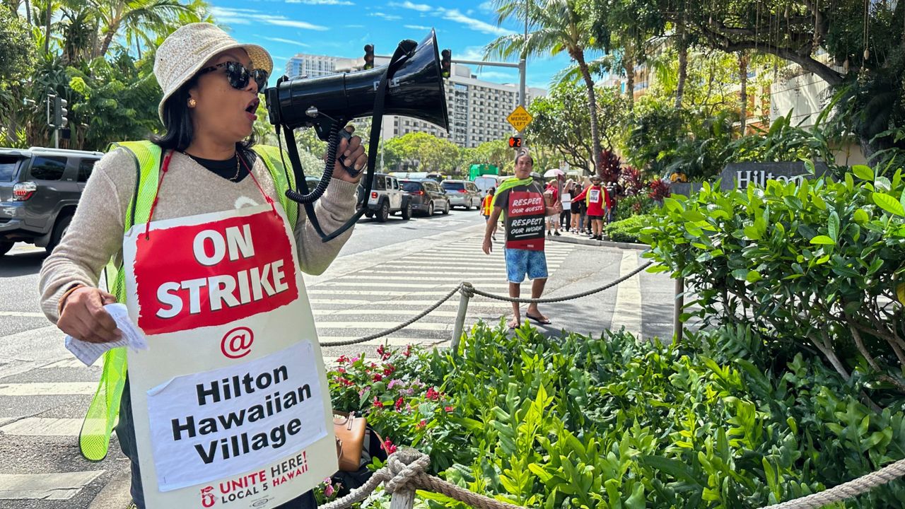 Estella Fontanilla, a housekeeper on strike from the Hilton Hawaiian Village, leads fellow hotel workers in strike chants on Tuesday, Sept. 24, 2024, in Honolulu. (AP Photo/Jennifer Sinco Kelleher)