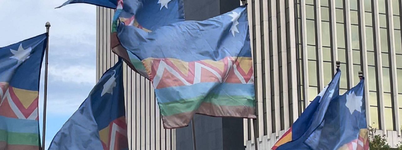 Hispanic Heritage Month flags wave in Clayton during a ceremony to place them in a courtyard behind the St. Louis County administration building in Clayton on Monday Sept. 16, 2024. (Spectrum News/Gregg Palermo)