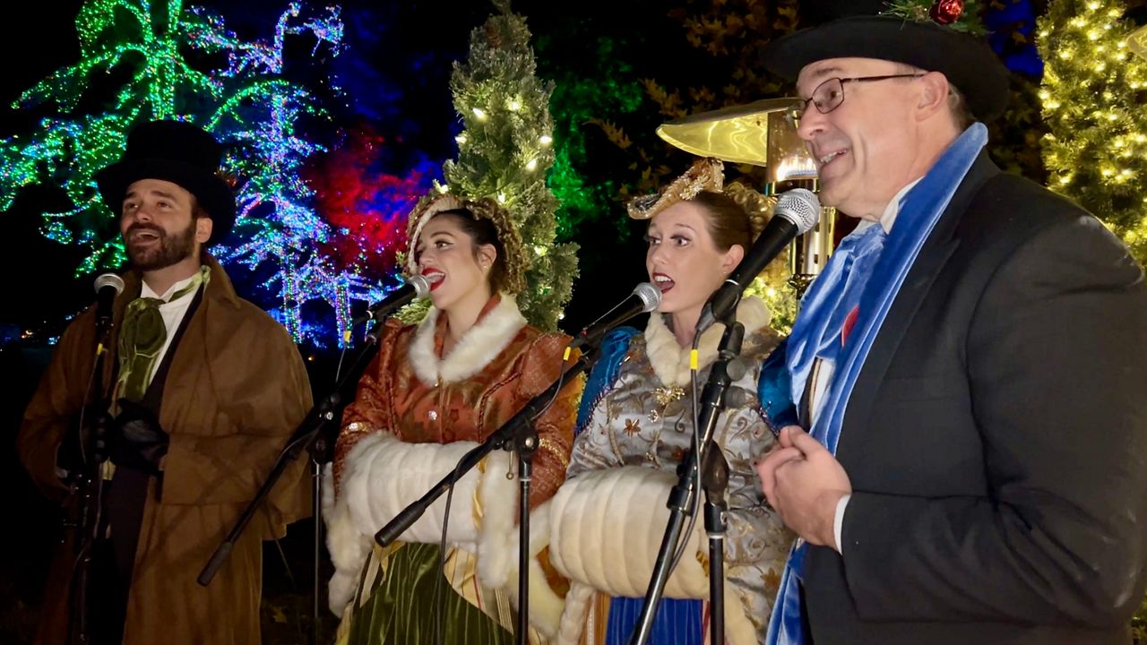 Carolers perform.