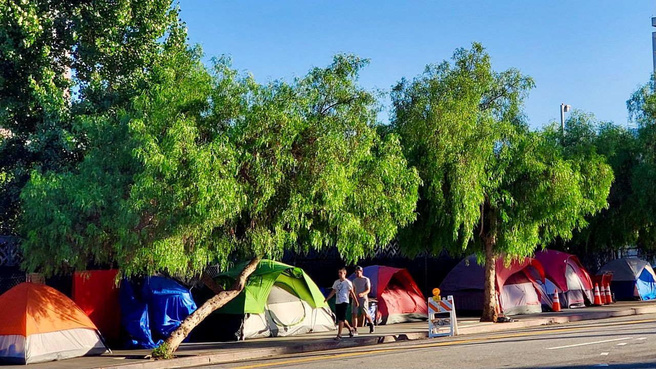 Residents walk through a homeless encampment in downtown Los Angeles (Spectrum News/Joseph Pimentel)