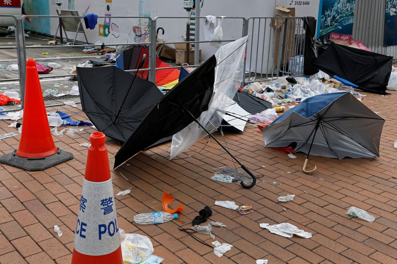 AP PHOTOS Umbrellas, a Hong Kong protest symbol, broken