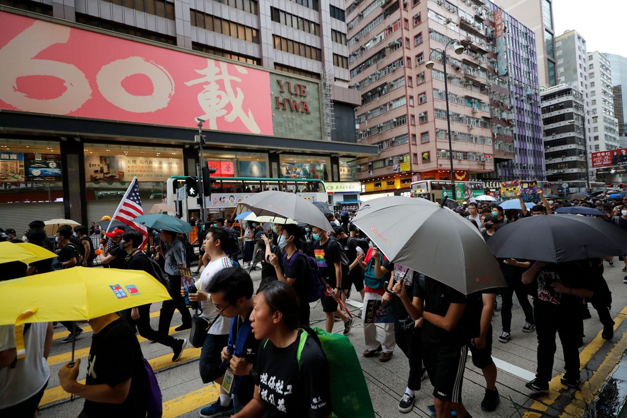 The Latest: HK protesters stream past designated end point