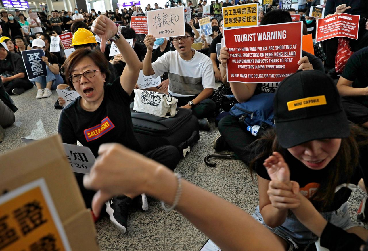 Hong Kong protesters take their cause to airport arrivals