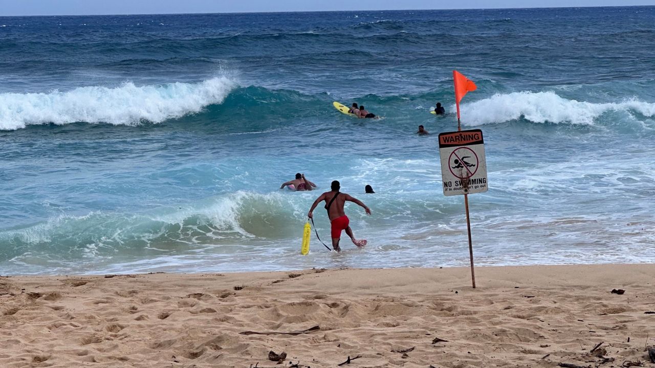 Three friends that all got stuck in the current and were unable to get to shore at Sandy Beach. (Courtesy Honolulu Ocean Safety)