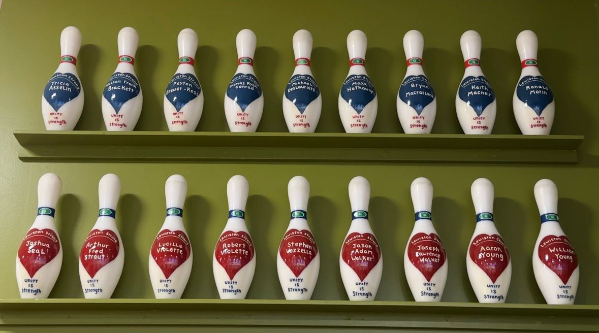 Eighteen bowling pins are on display at Just-in-Time Recreation to honor those killed at the bowling alley and at a nearby bar. (Spectrum News/Susan Cover)