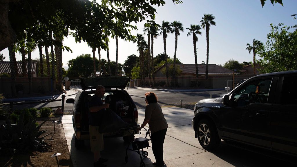 Maria Jackson, right, moves into a room at a home with the help of friend David Mcfarlan Monday, May 8, 2023, in Las Vegas. Jackson, a longtime massage therapist, lost her customers when the pandemic triggered a statewide shutdown in March 2020 and was evicted from her apartment earlier this year. (AP Photo/John Locher)