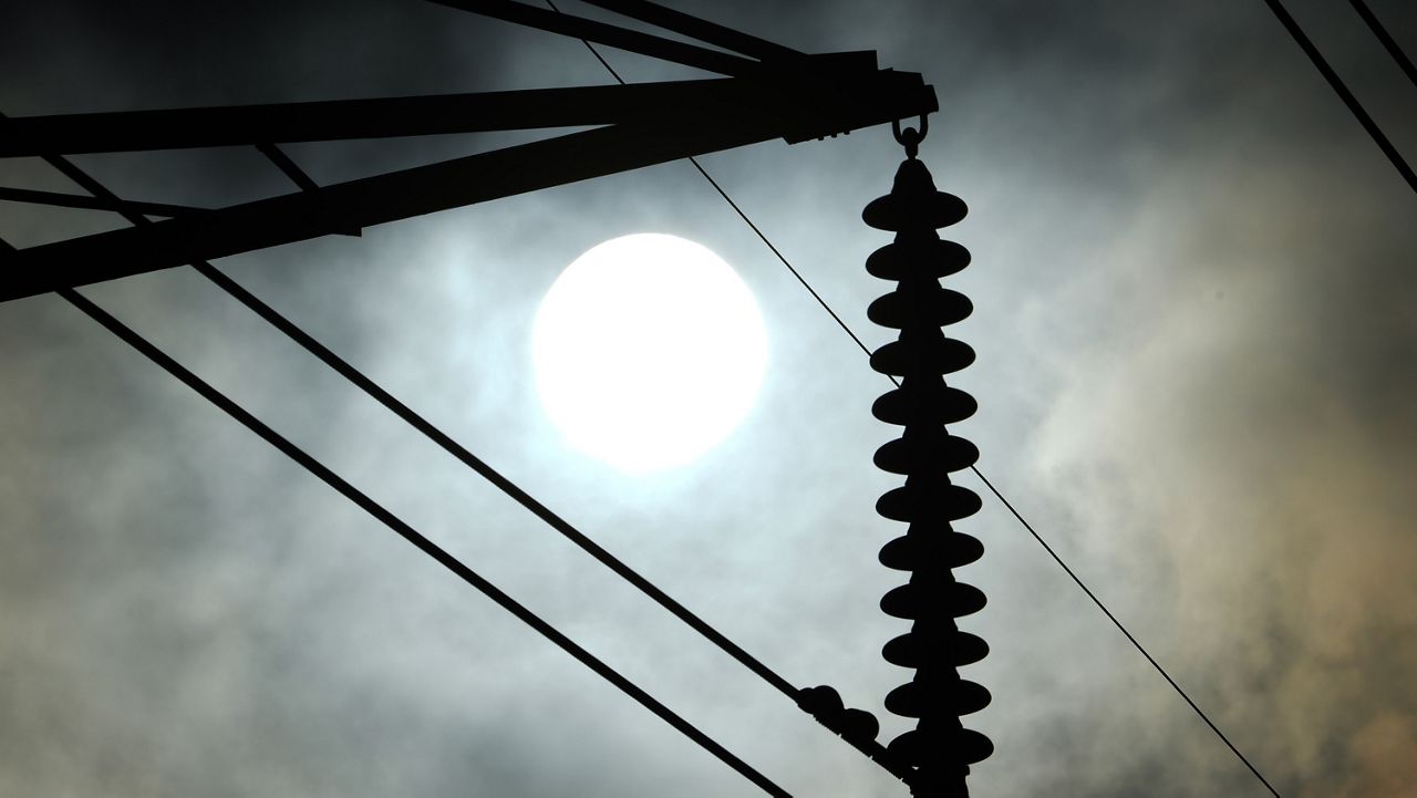 The sun rises over power lines Tuesday, June 27, 2023, in Houston. (AP Photo/David J. Phillip)