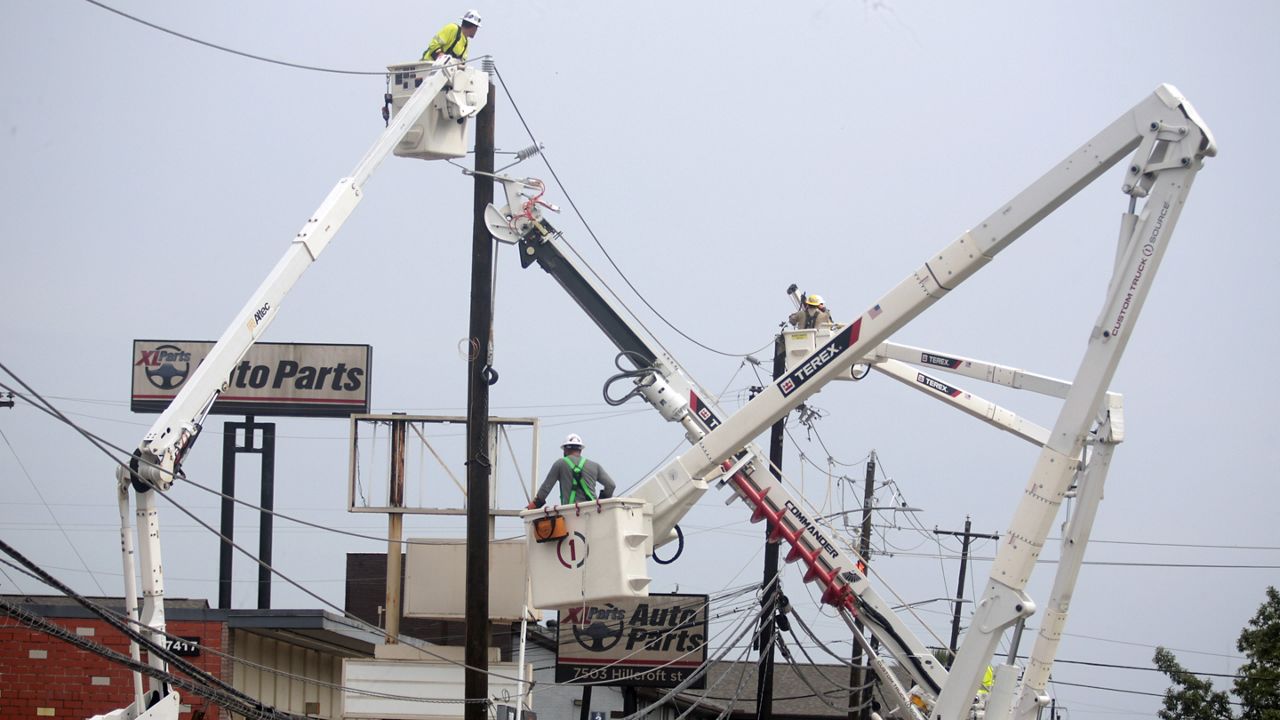 Workers fixing Houston power lines. (AP Photo)