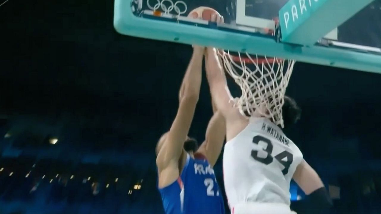 Former Iolani School standout Hugh Watanabe blocks Minnesota Timberwolves center Rudy Gobert during Tuesday's Japan-France Olympic basketball matchup. (Streamable.com video capture)