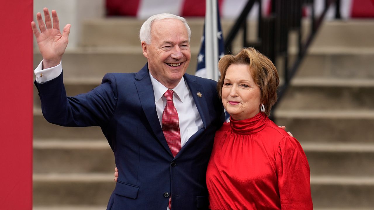 Former Arkansas Gov. Asa Hutchinson, left, embraces his wife, Susan Hutchinson, right, after she introduced him to formally announce his Republican campaign for president, Wednesday, April 26, 2023, in Bentonville, Ark. (AP Photo/Sue Ogrocki)