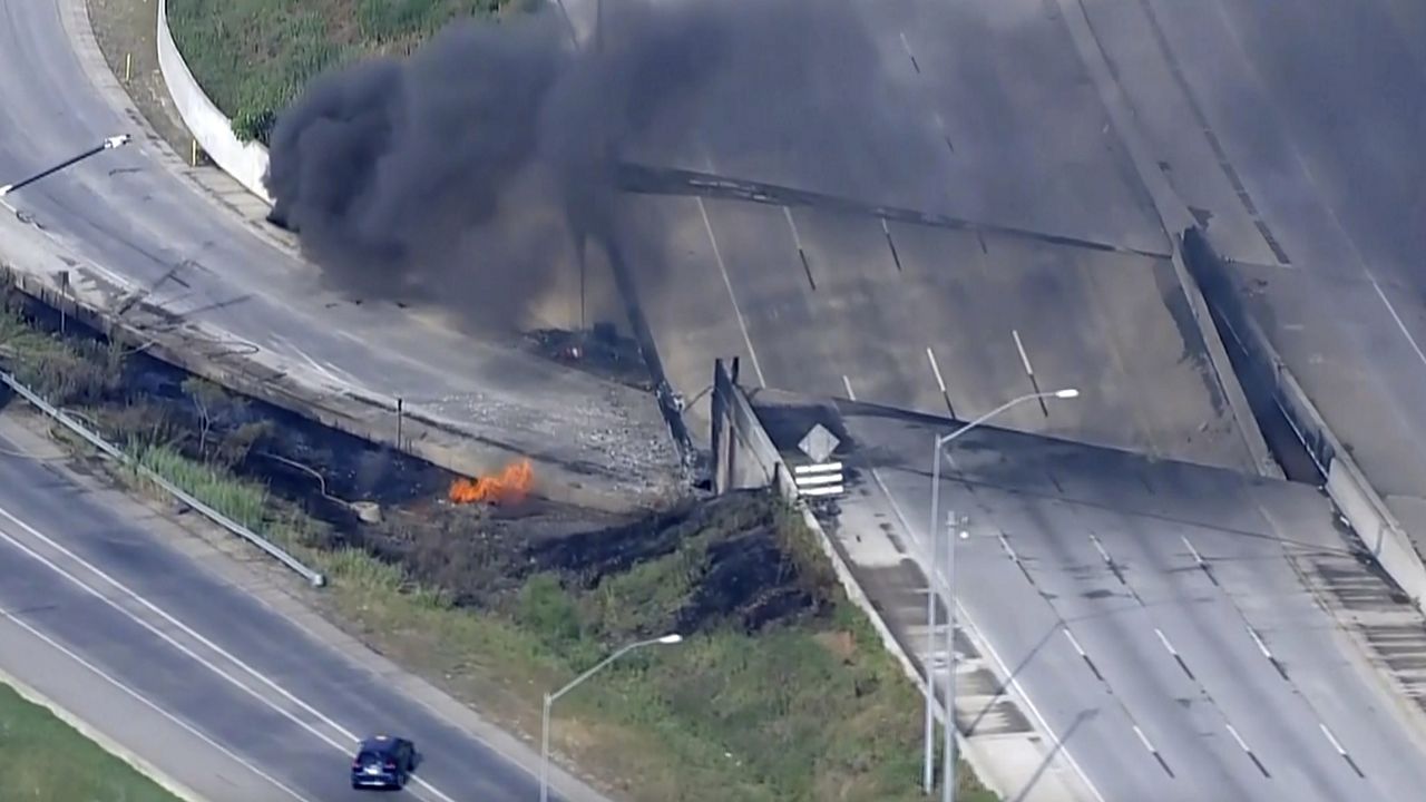 This screen grab from video provided by WPVI-TV/6ABC shows fire and smoke near the collapsed section of I-95 in Philadelphia on Sunday. (WPVI-TV/6ABC via AP)