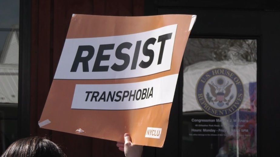 A sign with the words "resist transphobia"