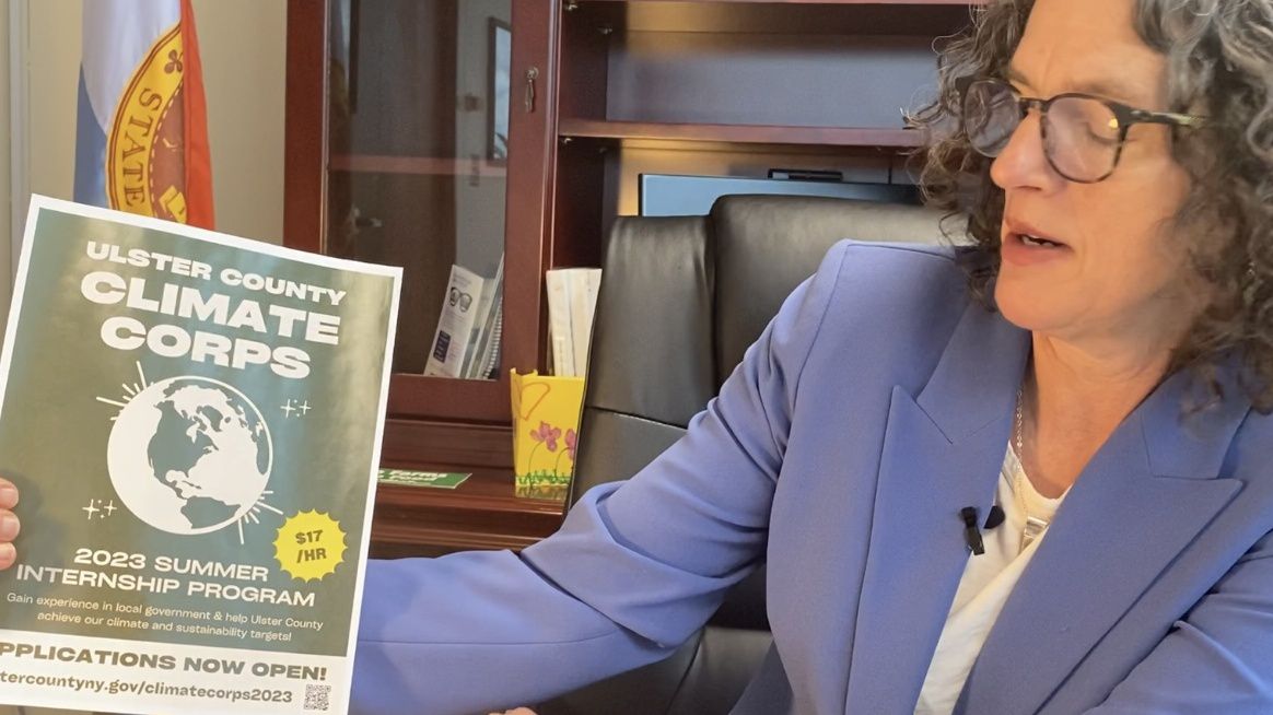 woman holds flyer