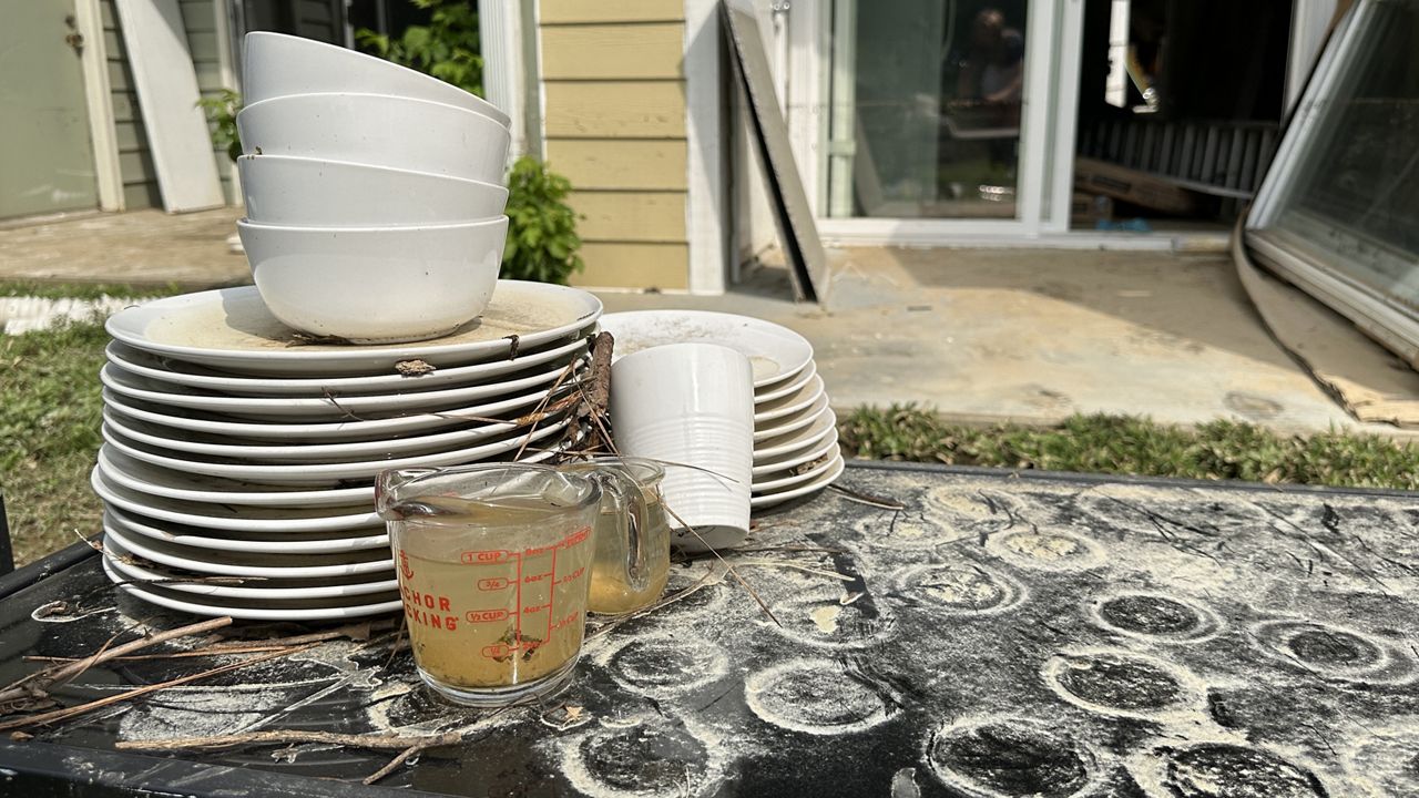 Standing flood water in a measuring cup from a home Chantal flooded in Carrboro.
