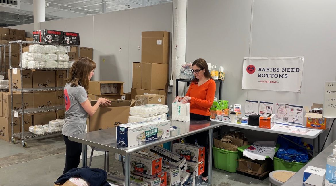 Meagan Lyon Leimena and Alicia Heacock packaging diapers at Babies Need Bottoms