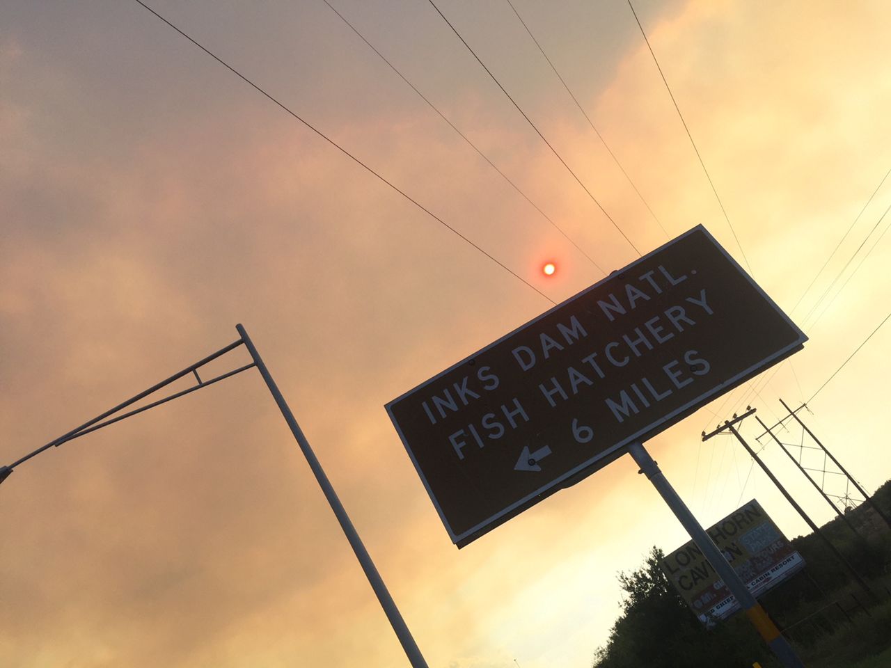 Smoke billowing from behind a sign