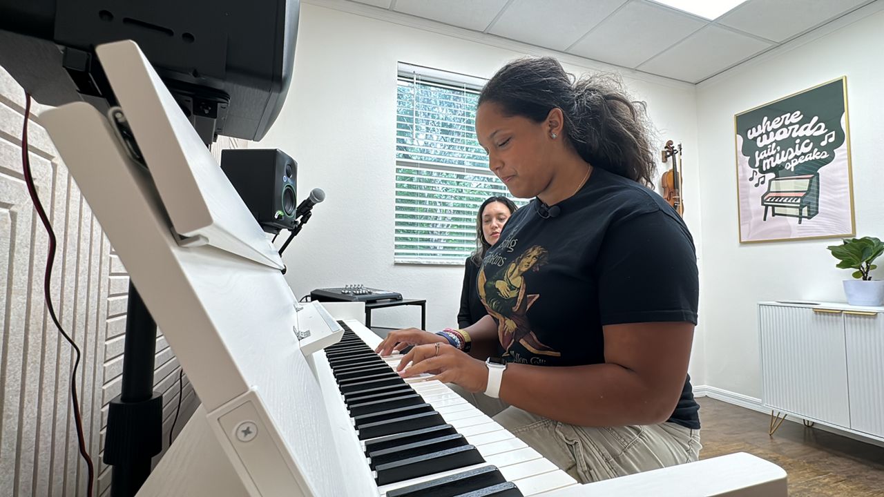 Lily Woodruff, a student at Premier Music Academy, has been attending for six years and plans to continue. (Spectrum News/Julia Hazel)