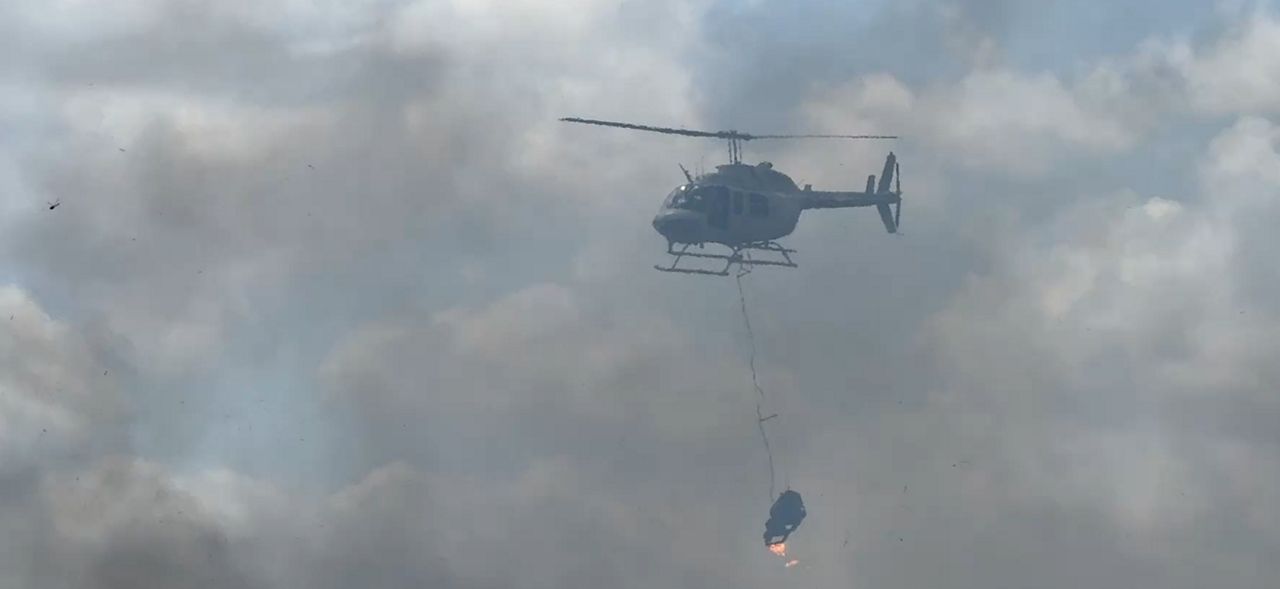 Helicopter drops fireballs during prescribed burn in Palm Bay. (File Photo)