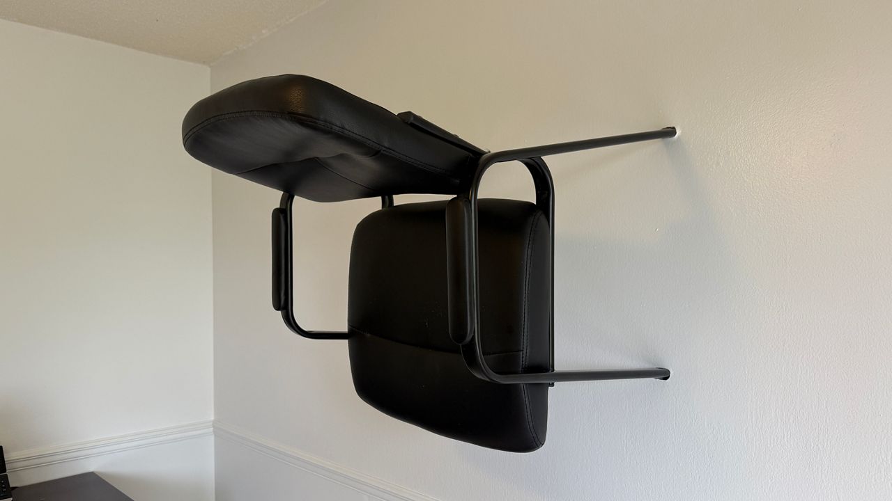 Vandals slammed a chair into a wall so hard it stuck. (Spectrum News)