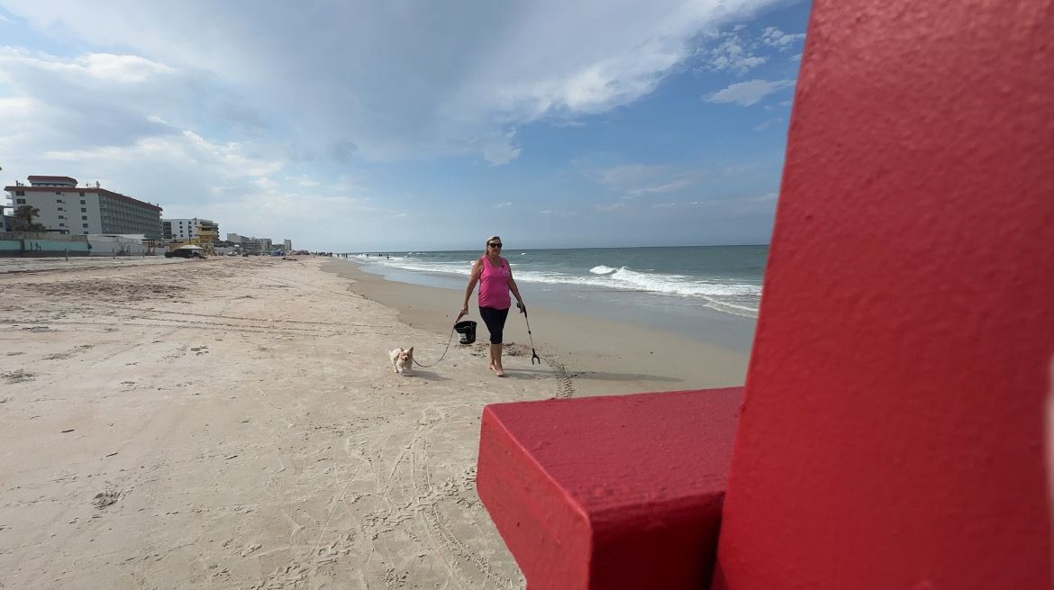 Nanette McKeel Petrella, President of Daytona Dog Beach, Inc., takes a walk on the beach with her dog Delilah. (Spectrum News/Devin Martin)