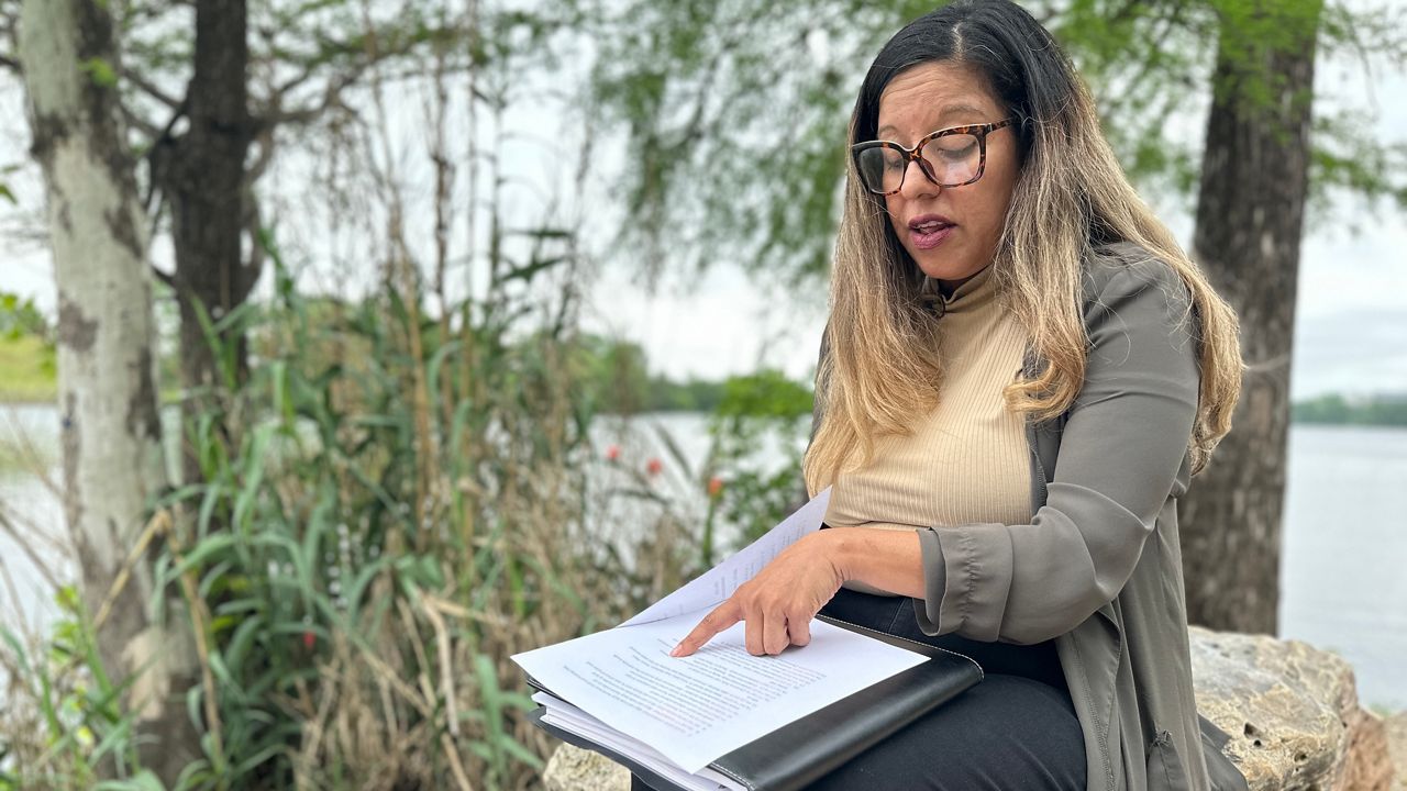 Bertha Rendon Delgado reads list of drowning deaths in Lady Bird Lake. (Spectrum News 1/Jamil Donith)
