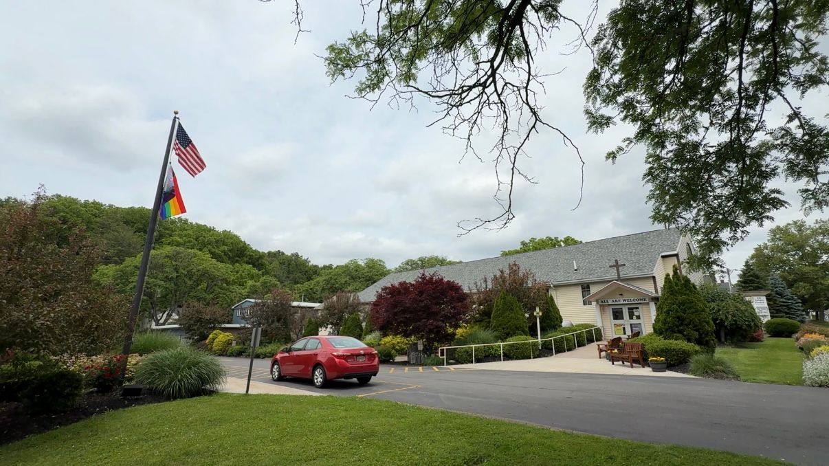 A new Pride flag flies proudly at All Saints Church. (Spectrum News 1/Natalie Mooney)