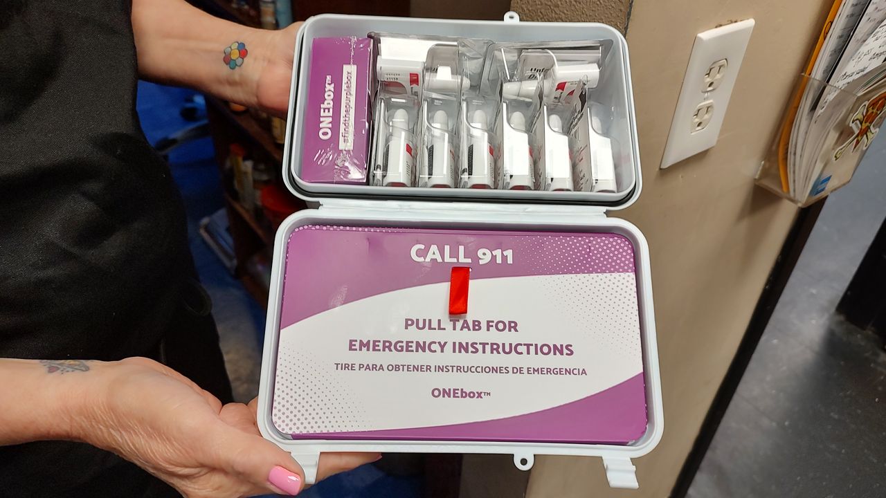 A ONEbox containing eight doses of Narcan and an informational tab. (Spectrum News)