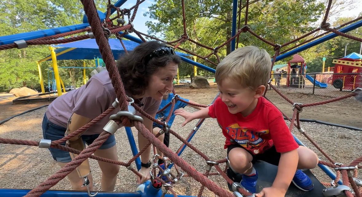 Kelli Brentnell playing with her kids on the playground.