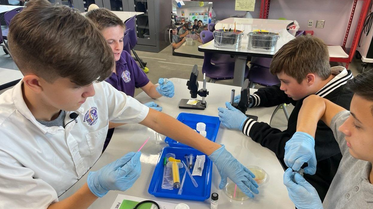 Members of Pinecrest Academy Space Coast's "Bacteria Boys" work on research that will be one of student 39 experiments sent to the International Space Station. (Spectrum News)