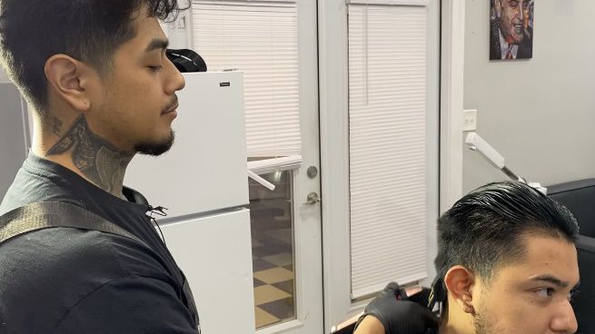 Barber cuts hair.