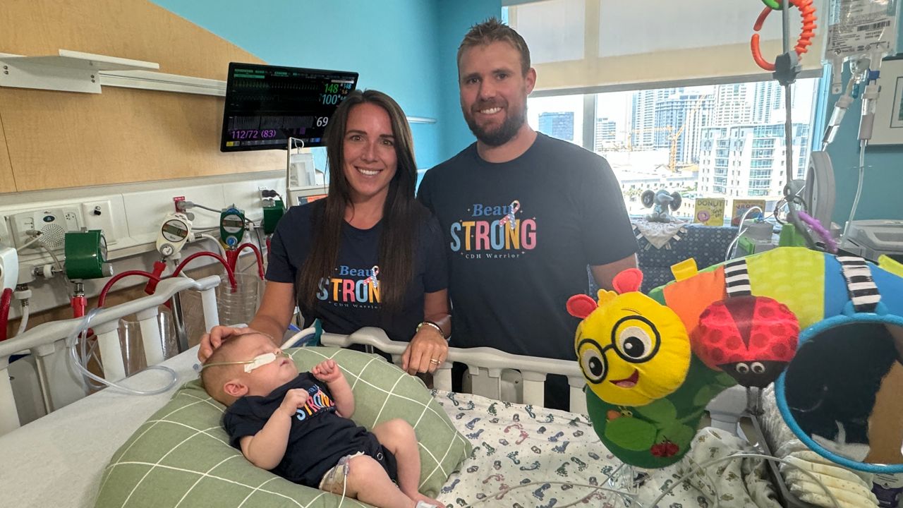 Bri (left), Jay (right) and Beau McPhillips at Johns Hopkins All Children's Center for Congenital Diaphragmatic Hernia. (Spectrum News/Melissa Eichman)