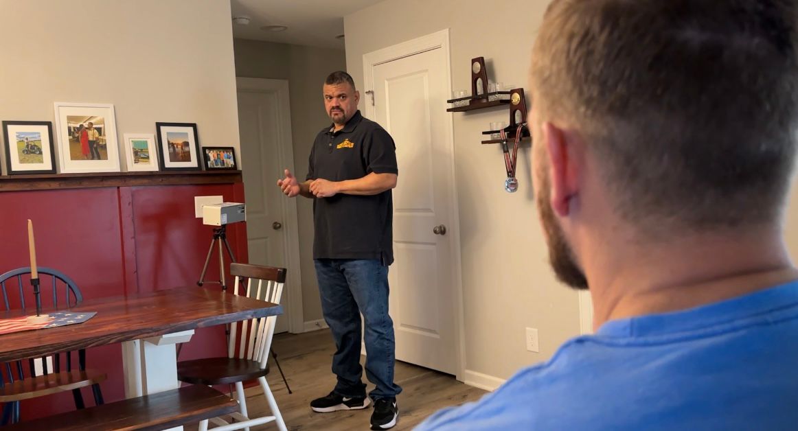 Abe Mendez explaining to a client how the radon test works.