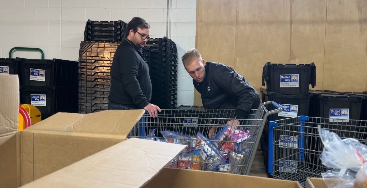 Blake Henkel and Ted Wilkinson packing boxes of food bags.