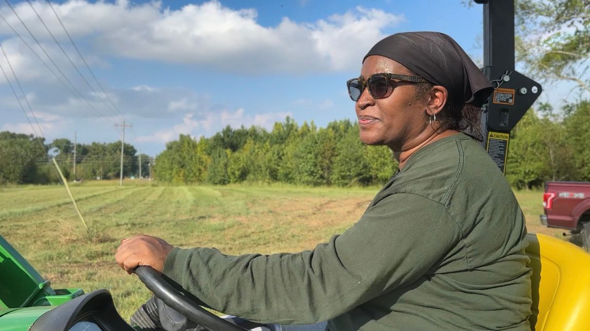 Joanne Spruill mows the future site of her produce mart and farm in Goldsboro. (Spectrum News 1/Rachel Boyd)