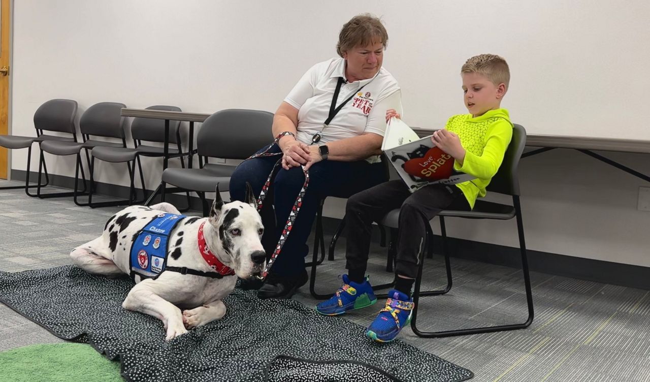Marcia and Chance reading with a kid at the 'Read With Me' event in February.